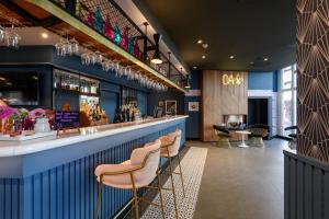 a bar at a restaurant with stools at T H E Darmstadt in Darmstadt