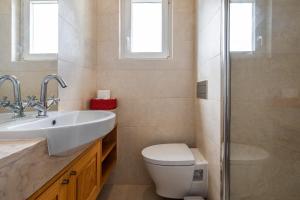 a bathroom with a toilet and a sink and a shower at Casa do Restelo in Lisbon