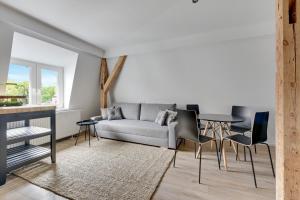 a living room with a couch and a table at Victus Apartamenty, Apartamenty Panamera in Sopot