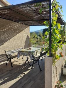 a table and benches on a patio with a view at L Appicciu in Ventiseri