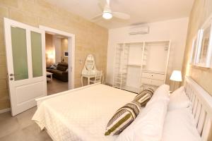 a bedroom with a bed and a living room at Luxury Maisonette in Vittoriosa