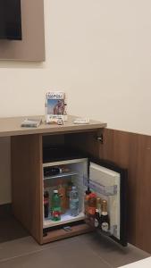 an open refrigerator under a desk with food at QUEEN MEDINA Centro Storico in Naples