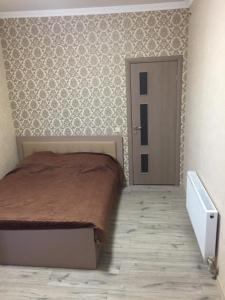 ein Schlafzimmer mit einem Bett und einer Tür darin in der Unterkunft Отель Переулок средний 16 in Kropywnyzkyj