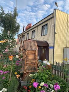 a flower garden in front of a building at Raduga Guest House in Petrozavodsk