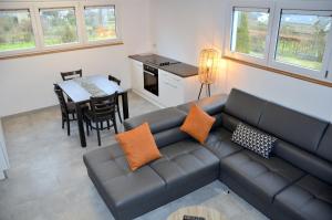 a living room with a couch and a table at Auberge Le Temps des Saveurs in Paliseul