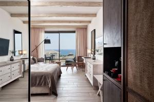 a hotel room with a bed and a view of the ocean at Mare Ayia Napa in Ayia Napa