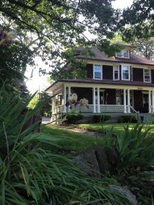 uma casa com ursinhos de peluche sentados no alpendre em Lion's Head B&B em Cataratas do Niágara