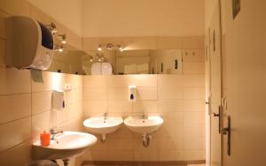 a bathroom with a sink and a mirror at Hostel One Home in Prague