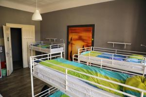 
a bed room with two beds and two windows at Hostel One Home in Prague
