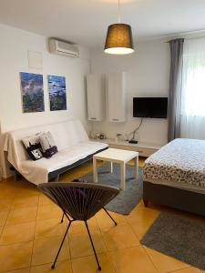 a living room with a bed and a table at Apartment Lara in Rab