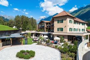 a view of a hotel with mountains in the background at Erlebnisort Gassenhof in Ridanna