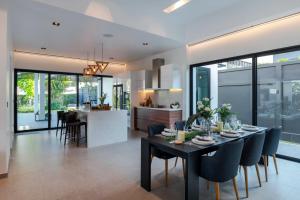 a dining room and kitchen with a table and chairs at Sivana Villas Hua Hin in Hua Hin