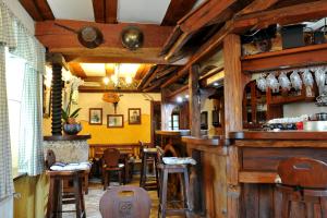 a bar with wooden bar stools in a restaurant at Gostilna in Prenočišča Brančurnik in Prevalje