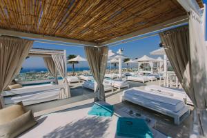 um pátio exterior com camas e vista para o oceano em Hotel Napa Suites (Adults Only) em Ayia Napa