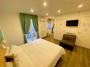 Postel nebo postele na pokoji v ubytování Mimì Rooms&Studios