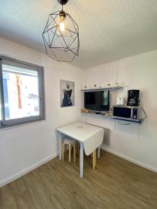 a small kitchen with a table and a window at Boost Your Immo Les Deux Alpes Kandahar 357 in Les Deux Alpes