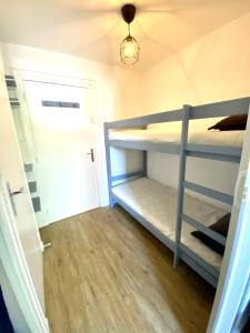 a room with two bunk beds and a door at Boost Your Immo Les Deux Alpes Kandahar 357 in Les Deux Alpes