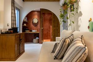 a living room with a couch and a mirror at The Artemis Hotel in Agia Anna Naxos