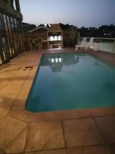 a swimming pool on a patio at night at Burd's Nest 215 in Shelly Beach