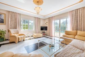 a living room with a couch and a glass table at Villa Son Ferrer in Santa Ponsa