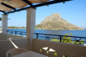 a balcony with a view of the ocean and a mountain at Lina studios in Kalymnos