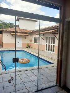 a view of a swimming pool through a sliding glass door at Franca Maya Hostel in Campinas