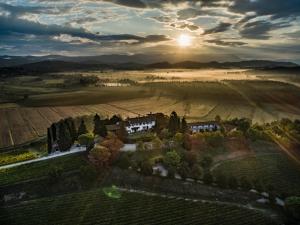 an aerial view of a house in a field with the sunset at Relais Russiz Superiore in Capriva del Friuli