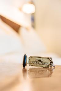 a metal lighter sitting on top of a table at Hotel Drei Hasen in Mariazell