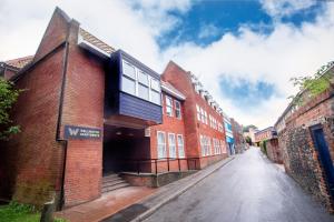 an empty street next to a red brick building at Wellington Apartments in Norwich