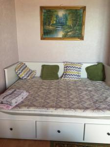 a bed in a room with a painting on the wall at Апартаменты с прекрасным видом на море в Актау in Aktau
