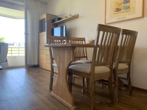 a kitchen with a table with chairs and a dining room at Haus am Deich Wohnung 2 in Dahme