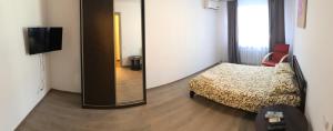 a small bedroom with a bed and a mirror at Апартаменты метро Тараса Шевченко in Kyiv