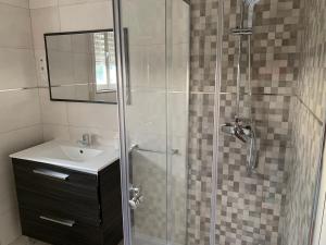 a bathroom with a shower with a sink and a mirror at Apartamento Playa de Carnota in Carnota +37 photos