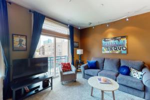a living room with a couch and a tv at Belltown Court II in Seattle
