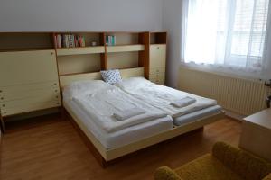 a bedroom with a bed and a book shelf at Granny's in Tvrdošín