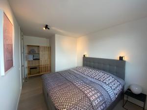 a bedroom with a large bed in a room at Coxy Penthouse Koksijde in Koksijde
