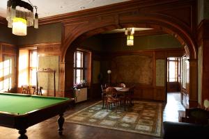 a room with a pool table and a dining room at Zamek Na Skale in Trzebieszowice