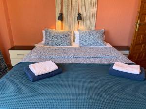 a bedroom with a bed with two pillows on it at Santa Ana in Casas Devesa