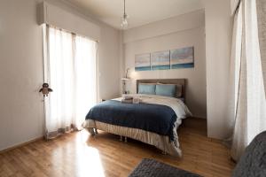 sypialnia z łóżkiem i dużym oknem w obiekcie EL GRECO bright, airy penthouse in trendy Petralona w Atenach
