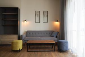 a living room with a couch and two chairs at Apartique Hotel in Jerusalem