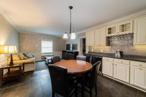 a kitchen and living room with a table and a couch at The Grand Resort in Howland Corners