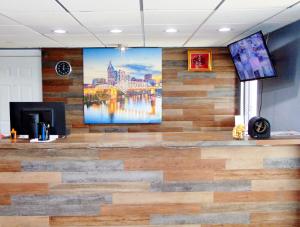 a lobby with a large painting on the wall at Somatel Nashville Airport in Nashville