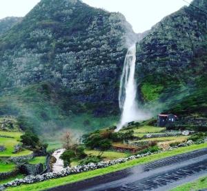 a waterfall on the side of a mountain at Pandora in Faja Grande +6 photos