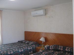 a hotel room with two beds and a air conditioner at HOTEL NUEVO SANTANDER in Ciudad Victoria