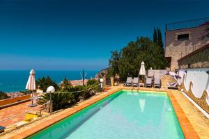 a swimming pool with a view of the ocean at Residence Agape in Cefalù