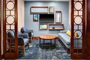 a living room with a couch and a table at Hyatt Place Atlanta Buckhead in Atlanta