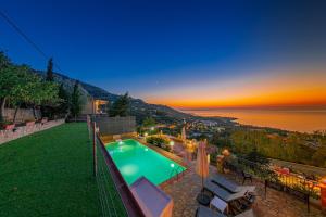 a backyard with a swimming pool and a view of the ocean at Residence Agape in Cefalù