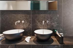 two bowls on a counter in a bathroom at Meo Design Suites & Spa in Catania