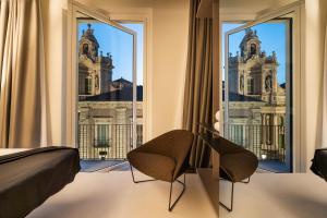 a hotel room with a view of the palace ofminster at Meo Design Suites & Spa in Catania