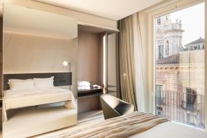 a hotel room with a bed and a window at Meo Design Suites & Spa in Catania
